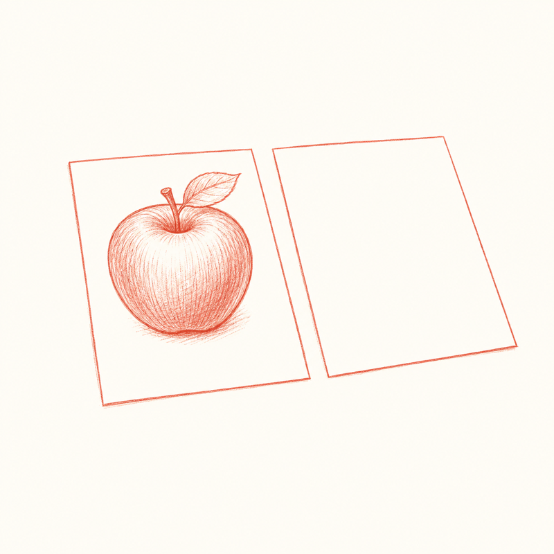 お手本のりんごの絵と、まだ何も描かれていない白い紙